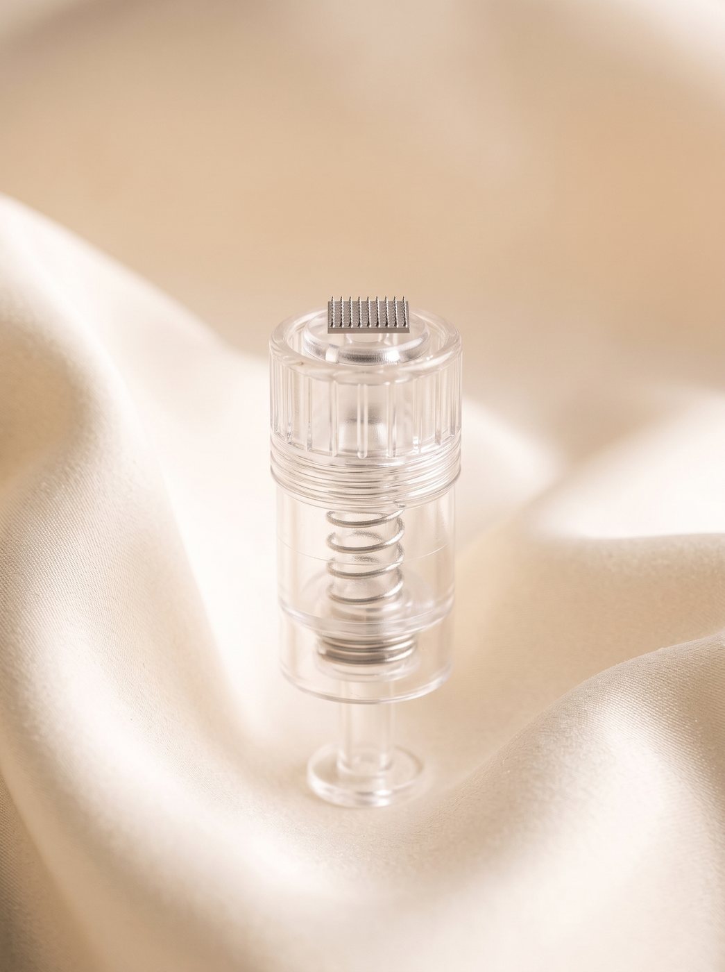 A transparent single-use cartridge on cream silk