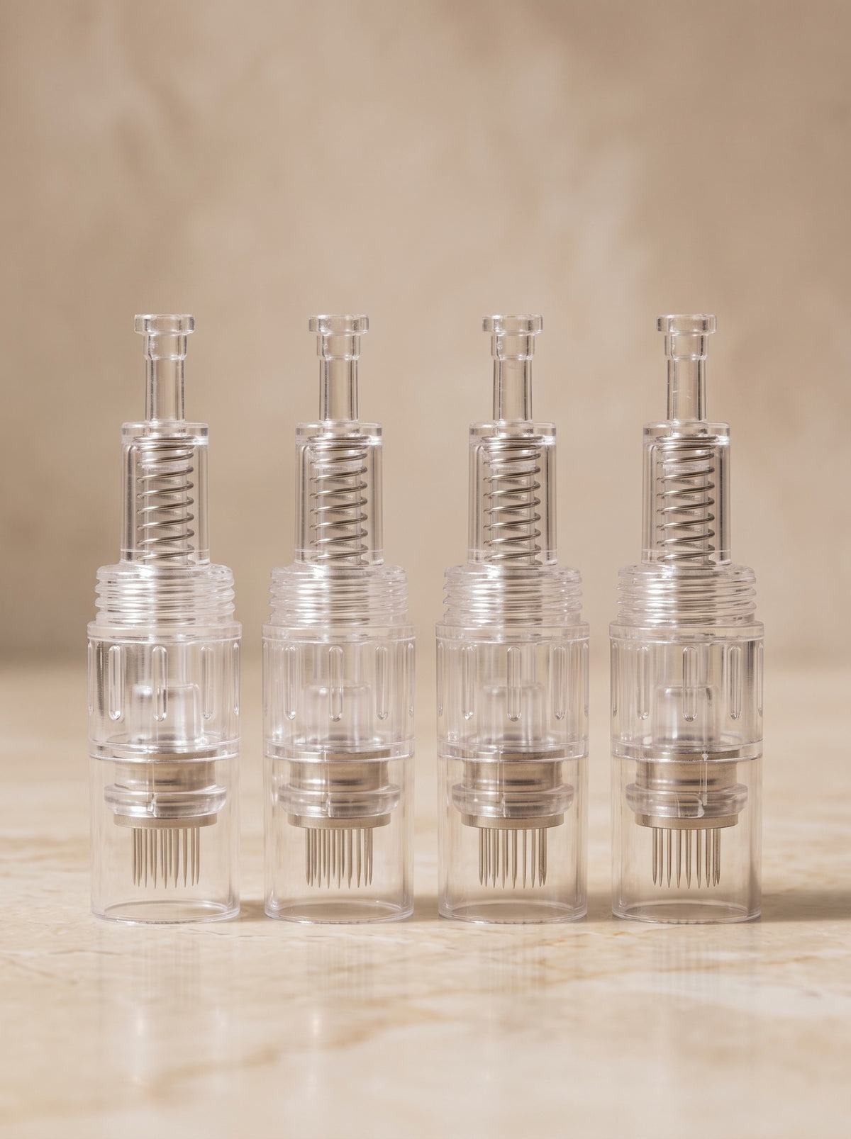 Four VISACE Pro 12-pin 2.0mm cartridges for the Derma Pen Pro on cream marble